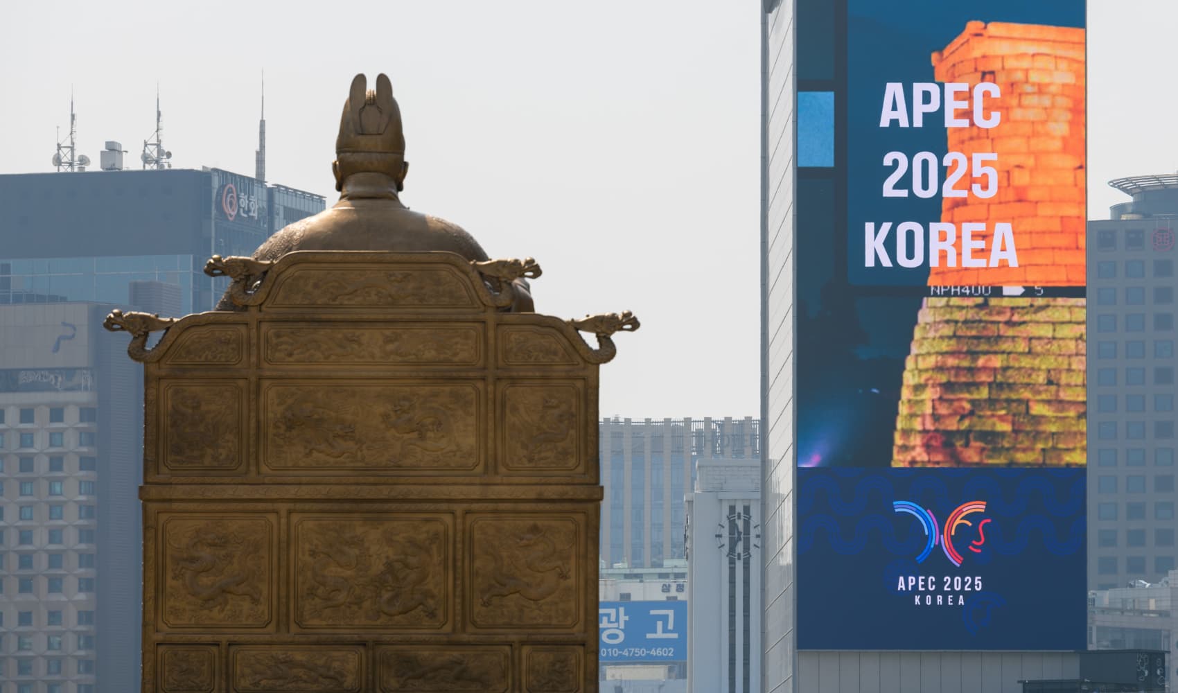SEOUL, SOUTH KOREA – 2025/04/16: An APEC 2025 large-scale promotional video and a statue of King Sejong the Great are seen at Gwanghwamun Square in central Seoul.