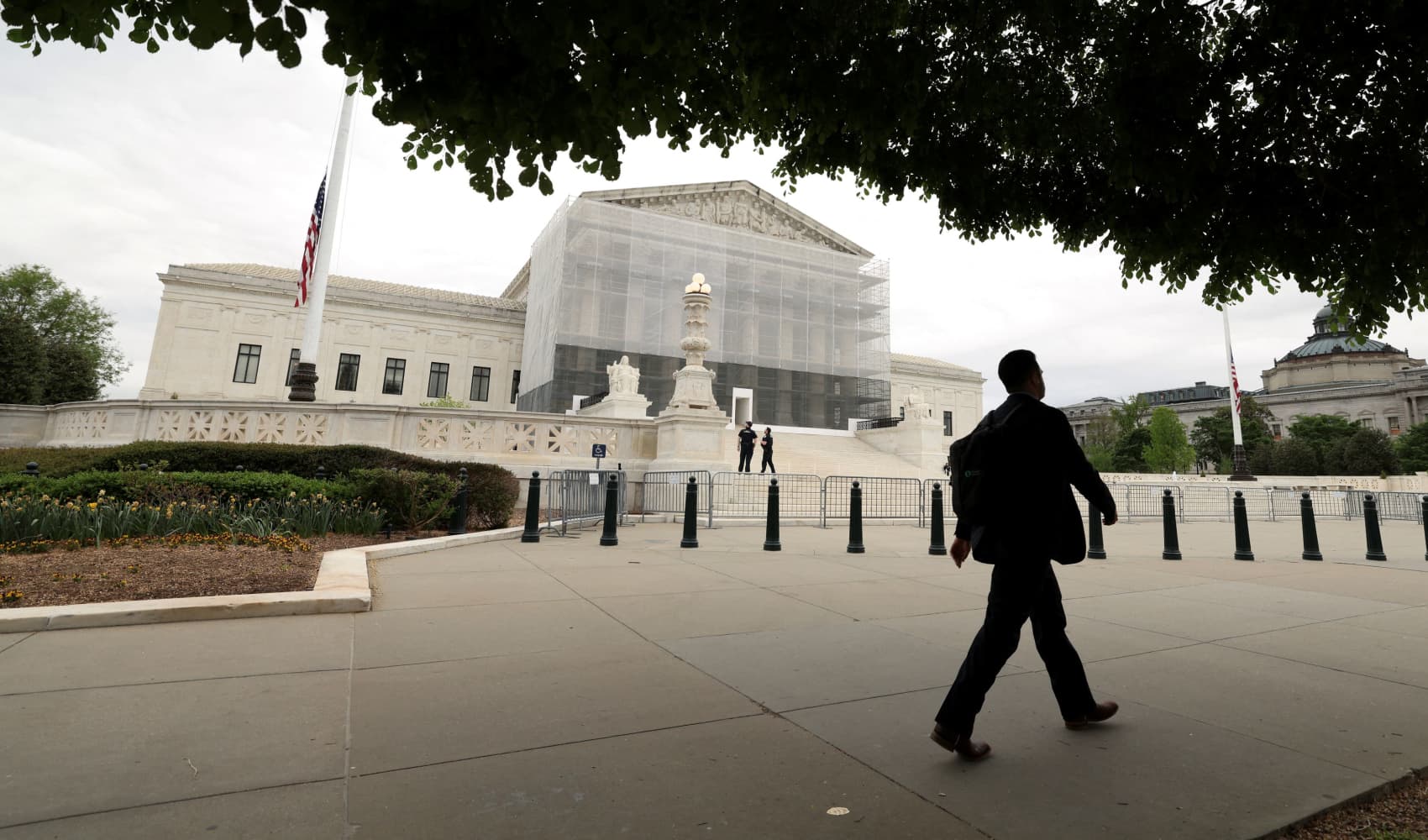 A person walks past the U.S. Supreme Court in Washington, D.C., U.S., April 21, 2025.